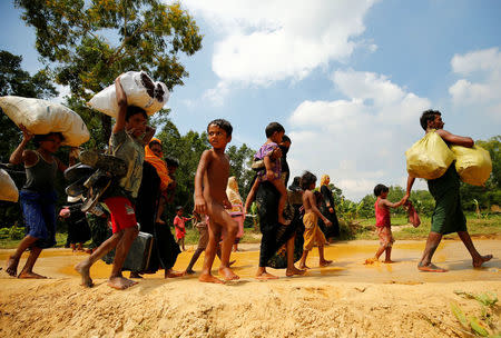 Rohingya people walk towards the makeshift shelter near the Bangladesh-Myanmar border, after being restricted by the members of Border Guards Bangladesh (BGB), to further enter into the Bangladesh side, in Cox’s Bazar, Bangladesh August 28, 2017. REUTERS/Mohammad Ponir Hossain