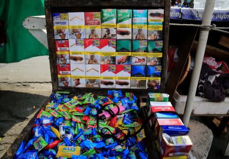 Different brands of cigarette packs are seen at a stall along a main street in metro Manila, Philippines May 19, 2017. REUTERS/Romeo Ranoco TEMPLATE OUT