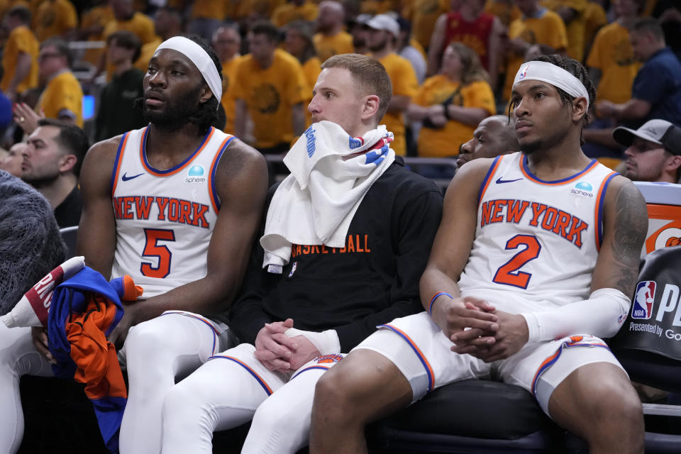 New York Knicks forward Precious Achiuwa, from left, guard Donte DiVincenzo and guard Miles McBride watch from the bench during the second half of Game 6 against the Indiana Pacers in an NBA basketball second-round playoff series, Friday, May 17, 2024, in Indianapolis. The Pacers won 116-103. (AP Photo/Michael Conroy)