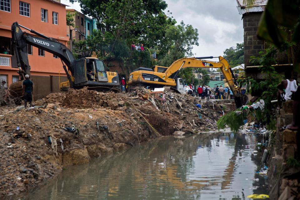 Backhoe machines work to remove debris after six small houses collapsed due to rains amid tropical storm Laura in Santo Domingo on August 23, 2020. - Tropical Storm Laura hammered Hispaniola island with heavy rain killing at least three people in the Dominican Republic and five in Haiti, and was set to become a hurricane on Tuesday. (Photo by Erika SANTELICES / AFP) (Photo by ERIKA SANTELICES/afp/AFP via Getty Images)