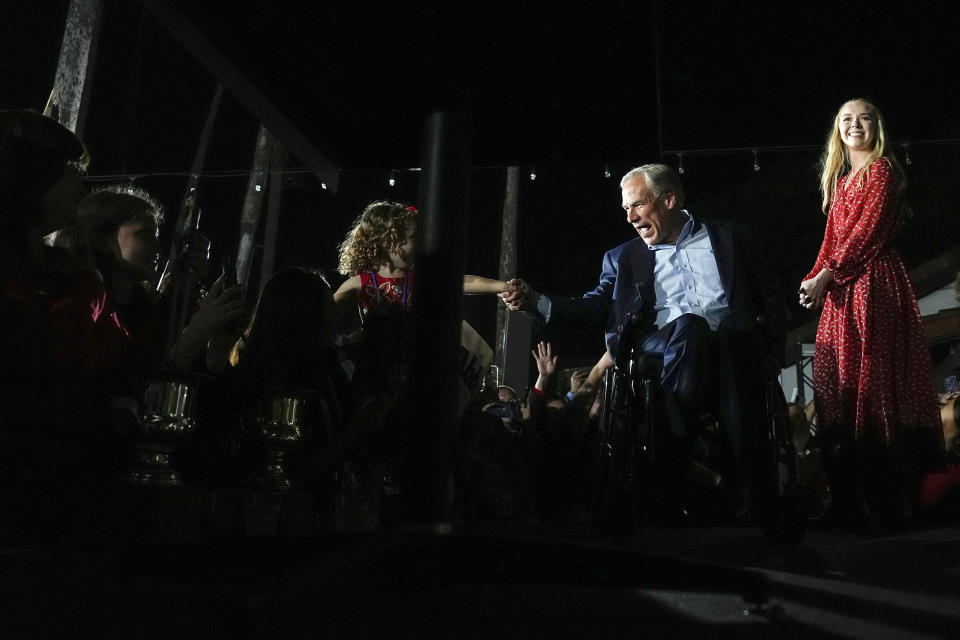 Texas Gov. Greg Abbott shakes hands with a child during an election night campaign event Tuesday, Nov. 8, 2022, in McAllen, Texas, with his daughter Audrey at right. (AP Photo/David J. Phillip)