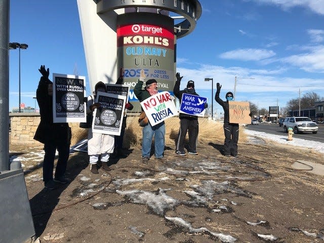 Iowans gathered at the corner of Douglas Avenue and Merle Hay Road Saturday, Feb. 5, to show their support for a nonmilitary solution to tensions between Europe and Russia.