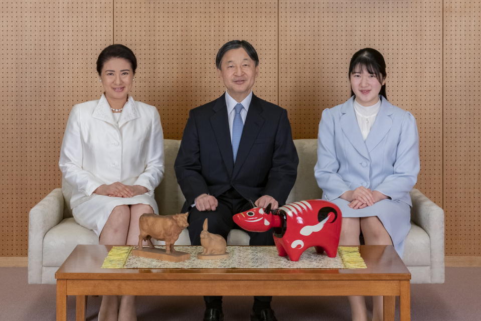 In this photo provided by the Imperial Household Agency of Japan, Japan's Emperor Naruhito, center, Empress Masako, left, and their daughter Princess Aiko pose for a photograph during a family photo session for the New Year at their Akasaka Estate residence in Tokyo, on Dec. 21, 2020. (The Imperial Household Agency of Japan via AP)