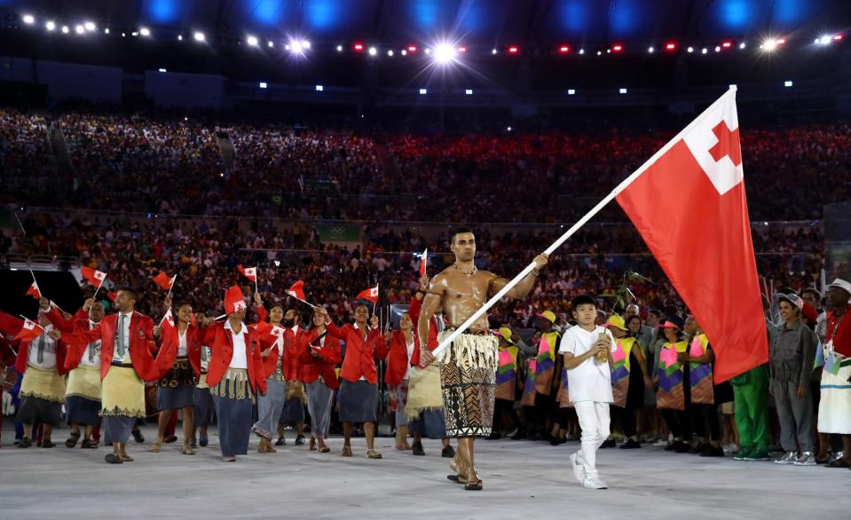 <p>Pita Nikolas Aufatofua of Tonga carries the flag during the Opening Ceremony of the Rio 2016 Olympic Games at Maracana Stadium on August 5, 2016 in Rio de Janeiro, Brazil. (Photo by Cameron Spencer/Getty Images) </p>