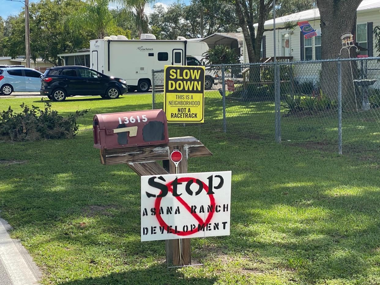 Signs opposing the development of the Asana Ranch line the streets of Port Hatchineha, nestled along its namesake lake at the end of Lake Hatchineha Road.