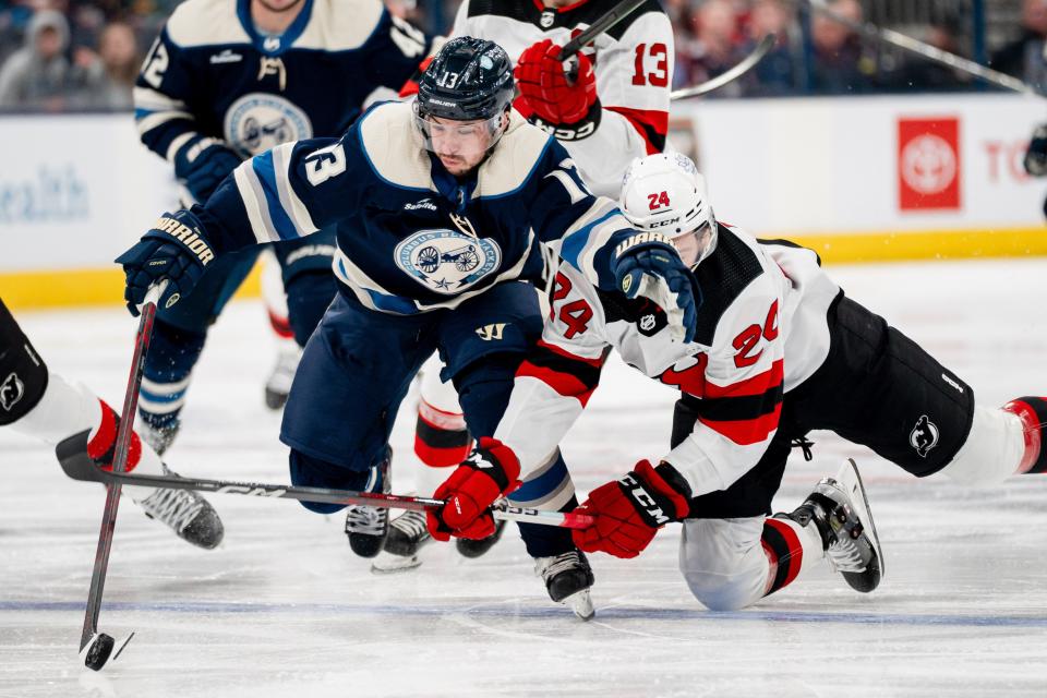 Dec 16, 2023; Columbus, Ohio, USA;
Columbus Blue Jackets left wing Johnny Gaudreau (13) fights New Jersey Devils defenseman Colin Miller (24) for the puck during the third period of their game on Saturday, Dec. 16, 2023 at Nationwide Arena.