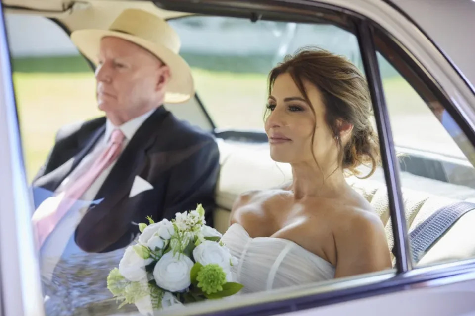 Alf Stewart and Leah Patterson in a vehicle before Leah's wedding. 