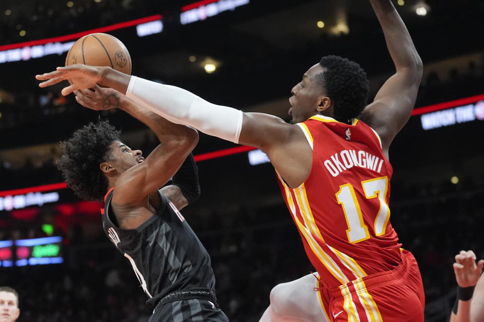 Houston Rockets guard Jalen Green (4) shoots as Atlanta Hawks forward Onyeka Okongwu (17) defends during the first half of an NBA basketball game Saturday, Feb. 10, 2024, in Atlanta. (AP Photo/John Bazemore)