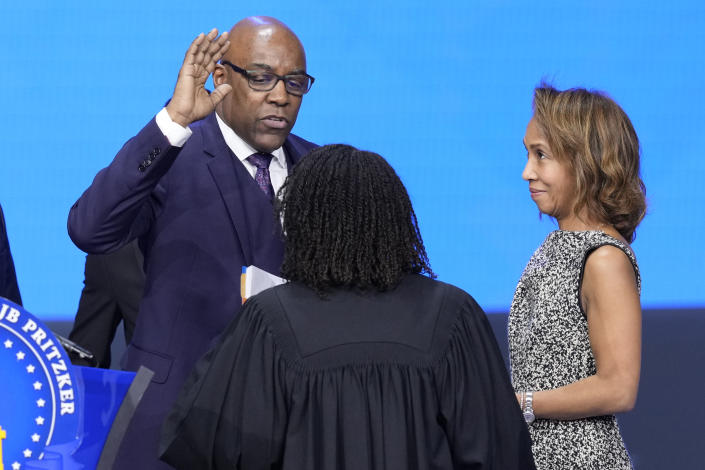 Illinois Attorney General Kwame Raoul takes the oath of office from Joy V. Cunningham, Illinois Supreme Court Associate Justice as his wife Dr. Lisa Moore watches during ceremonies Monday, Jan. 9, 2023, in Springfield, Ill. (AP Photo/Charles Rex Arbogast)