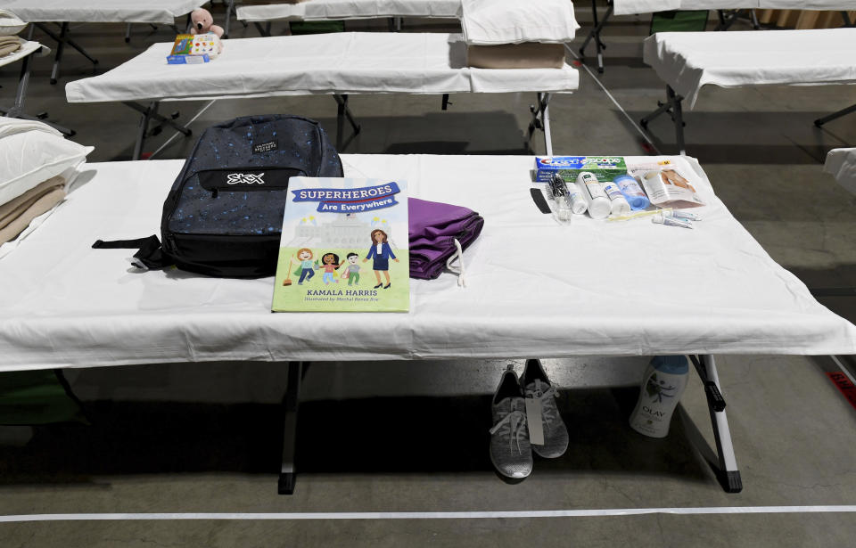 A sleeping area set up inside exhibit hall B of the Long Beach Convention Center, Thursday, April 22, 2021, in Long Beach, Calif., where migrant children found at the U.S.-Mexico border without a parent will be temporarily housed. The beds are in pods of 30. The center is able to house up to 1,000 children and the first children are expected to arrive Thursday afternoon. (Brittany Murray/The Orange County Register via AP, Pool)