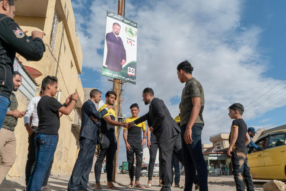 “We have great athletes here in our neighborhood, but they don’t get any resources,” says Abdullah, meeting a group of young men in Mosul. (Photo: Shawn Carrié for Yahoo News)