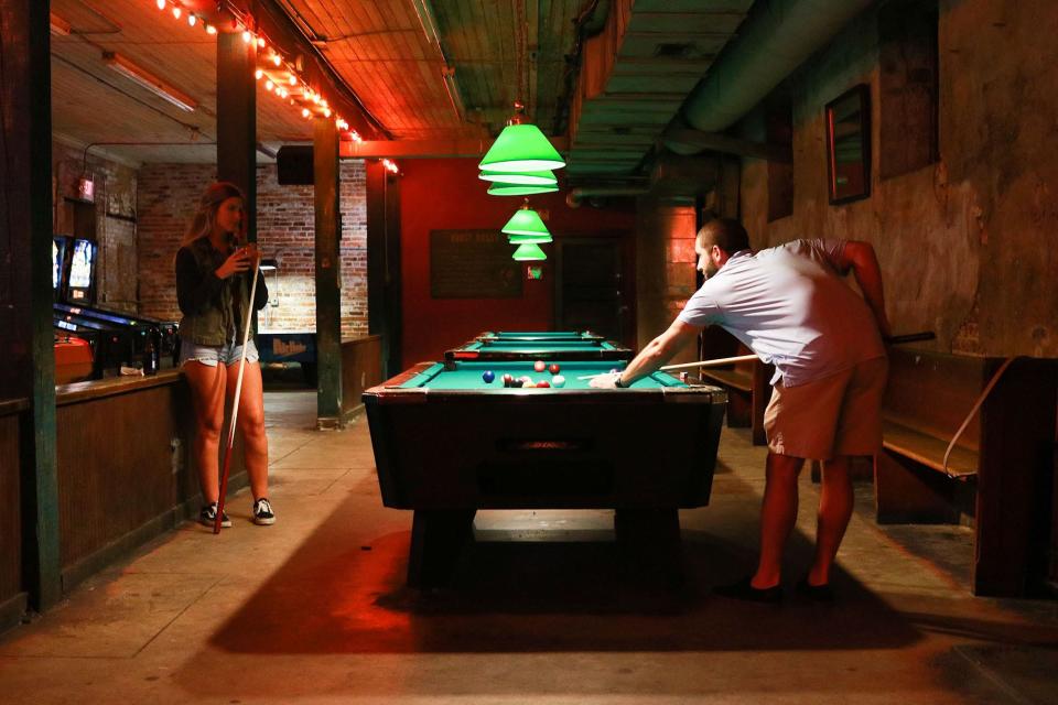 Chloe Coombs and Dillon Caraway play a game of pool at the Blue Post in 2018. The bar celebrates its 25th anniversary Oct. 1.
