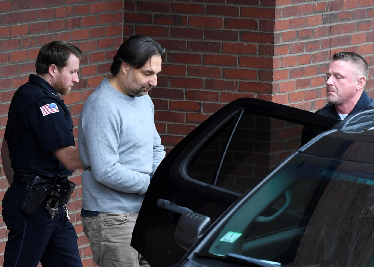 Two police officers escort Brian Walshe out of court and into a car following his arraignment.