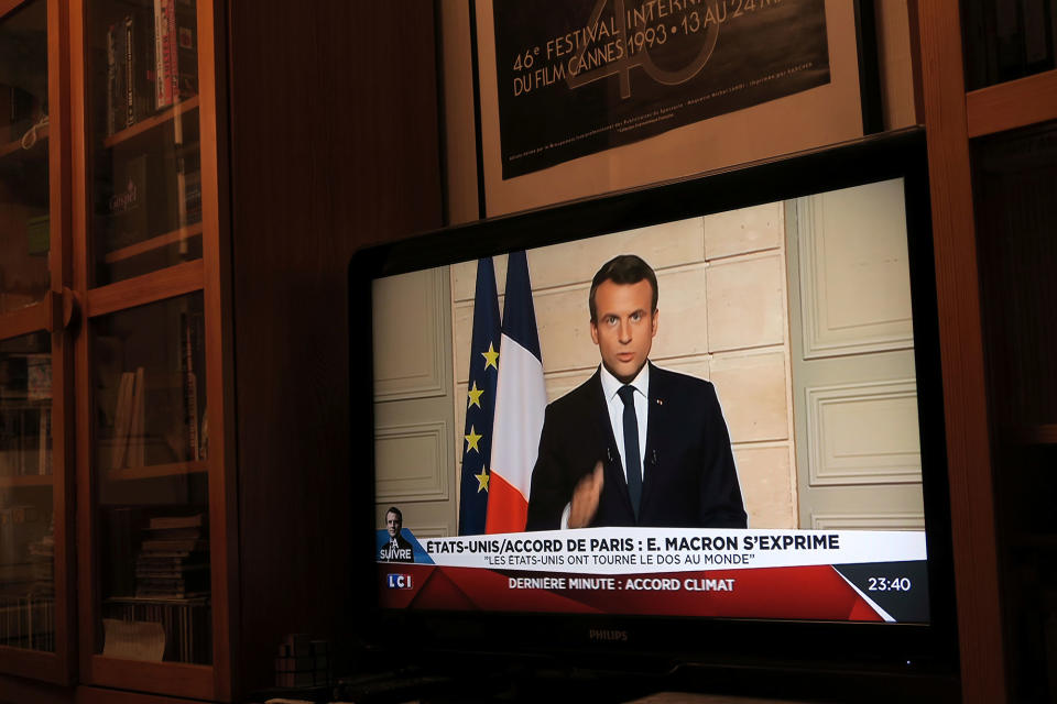 French President Emmanuel Macron, seen on TV, speaks from the Elysee Palace