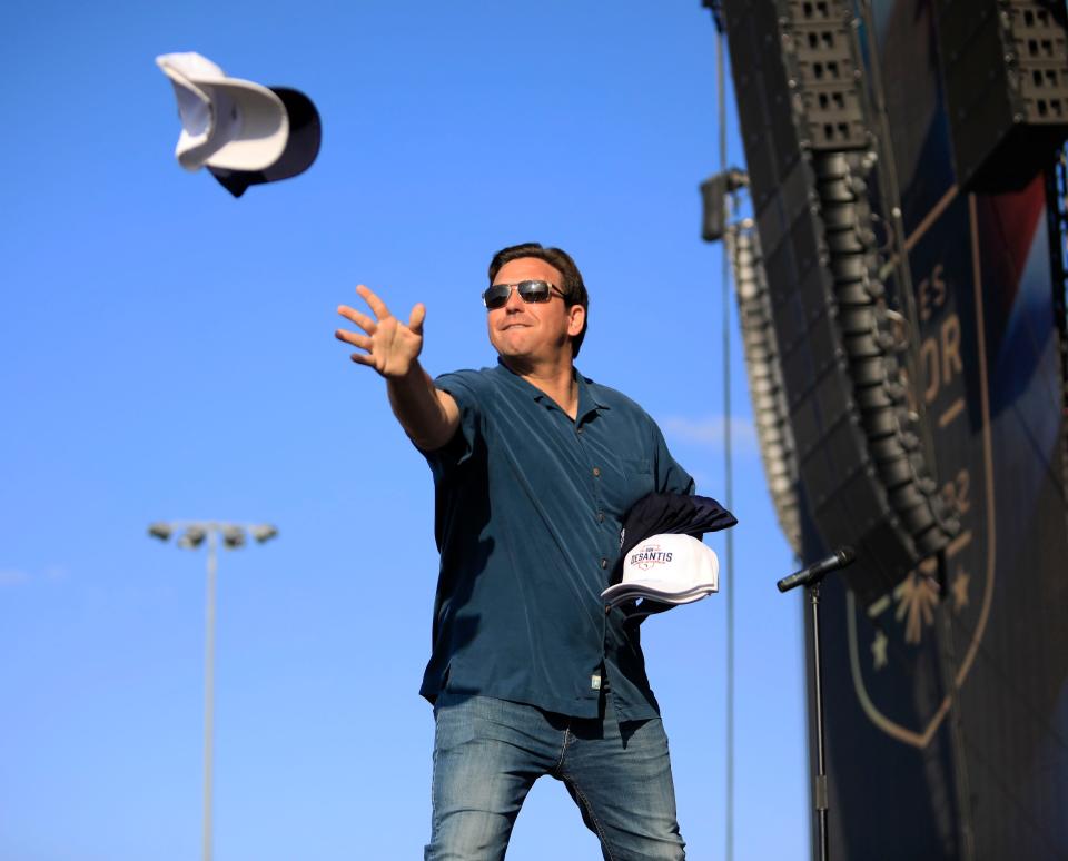 Florida Gov. Ron DeSantis tosses hats to the crowd at the Heroes Honor Festival at Daytona International Speedway in Daytona Beach on Saturday, May 28, 2022.