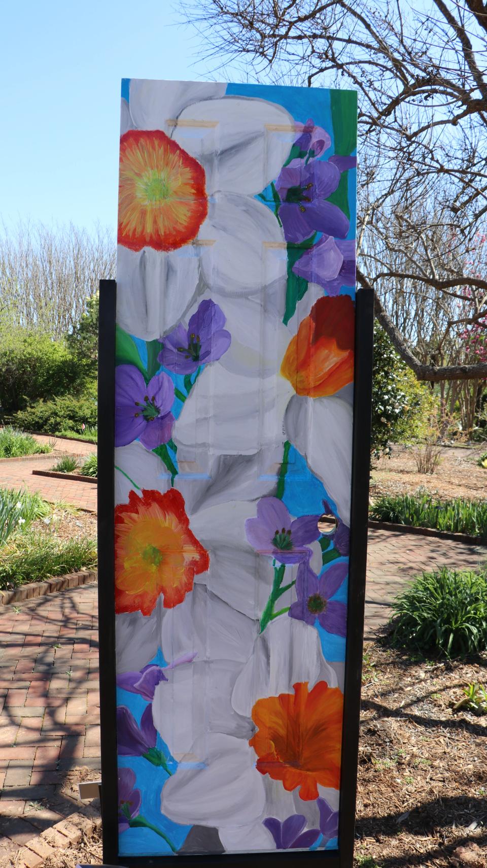 More than two dozen painted doors are on display at Daniel Stowe Botanical Garden as part of a project with Highland School of Technology students.
