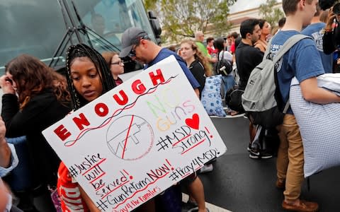 Students prepare before a rally to put pressure on the state's Republican-controlled Legislature to consider a sweeping package of gun-control laws - Credit: Gerald Herbert/AP