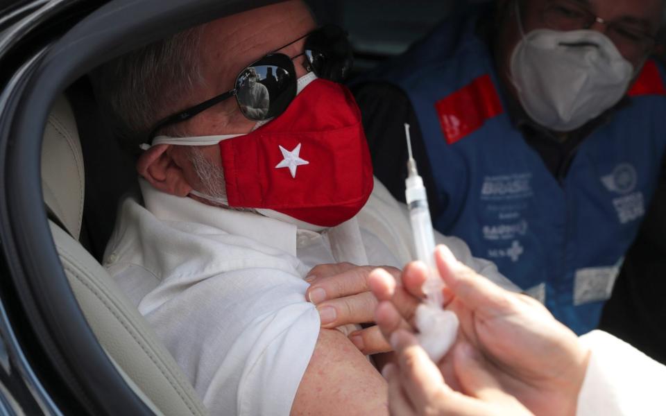 Former Brazilian President Luiz Inacio Lula da Silva watches as a nurse prepares a dose of Sinovac's vaccine  - Reuters