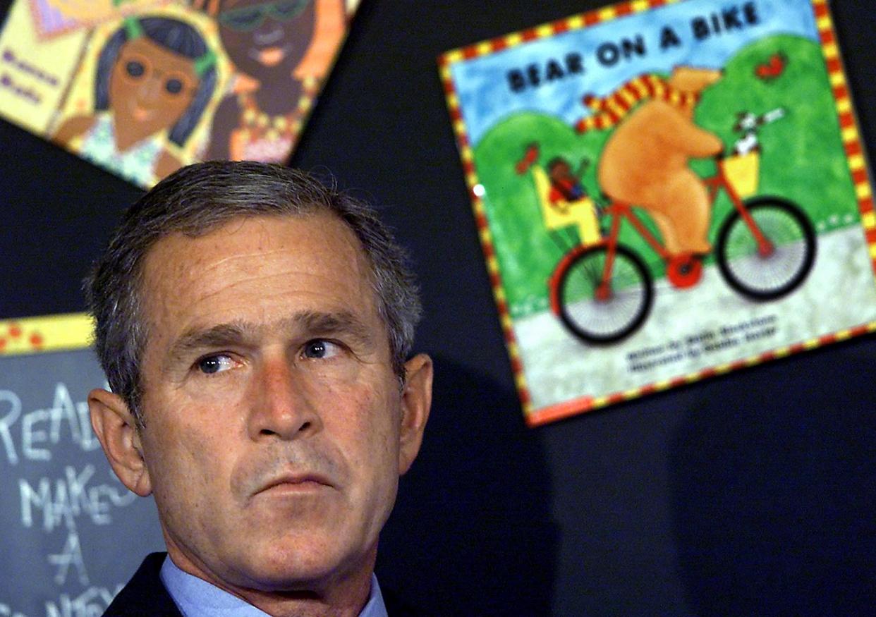 Then-president George W Bush learns the United States is under attack on 11 September, 2001 (AFP via Getty Images)