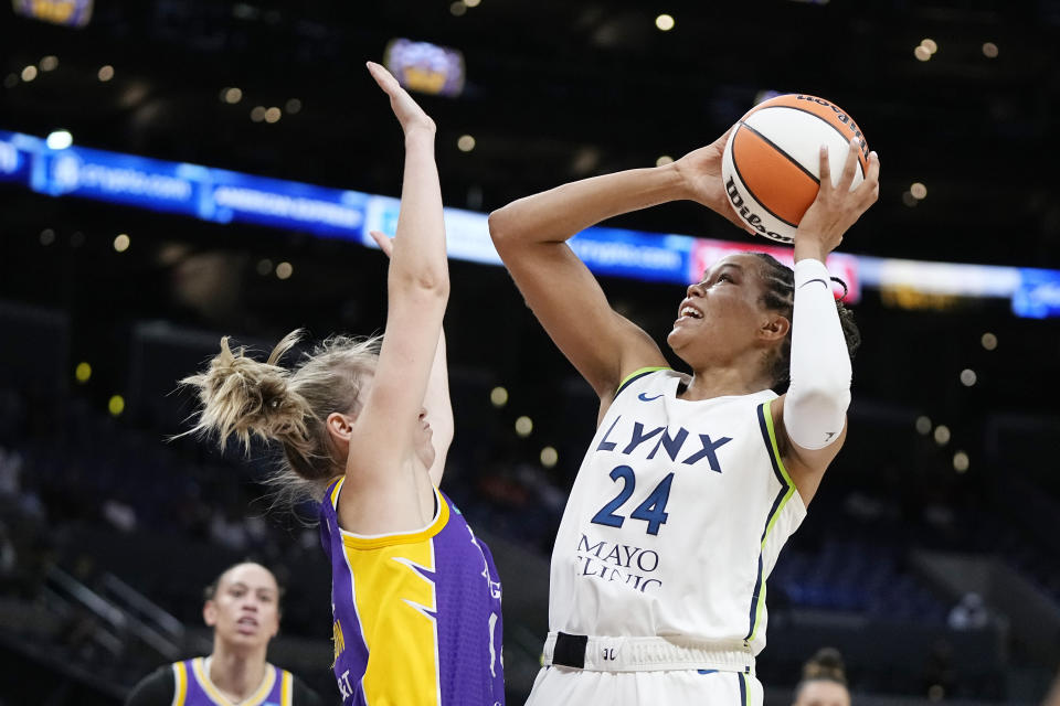 Minnesota Lynx forward Napheesa Collier, right, shoots as Los Angeles Sparks Karlie Samuelson defends during the first half of a WNBA basketball game Tuesday, June 20, 2023, in Los Angeles. (AP Photo/Mark J. Terrill)