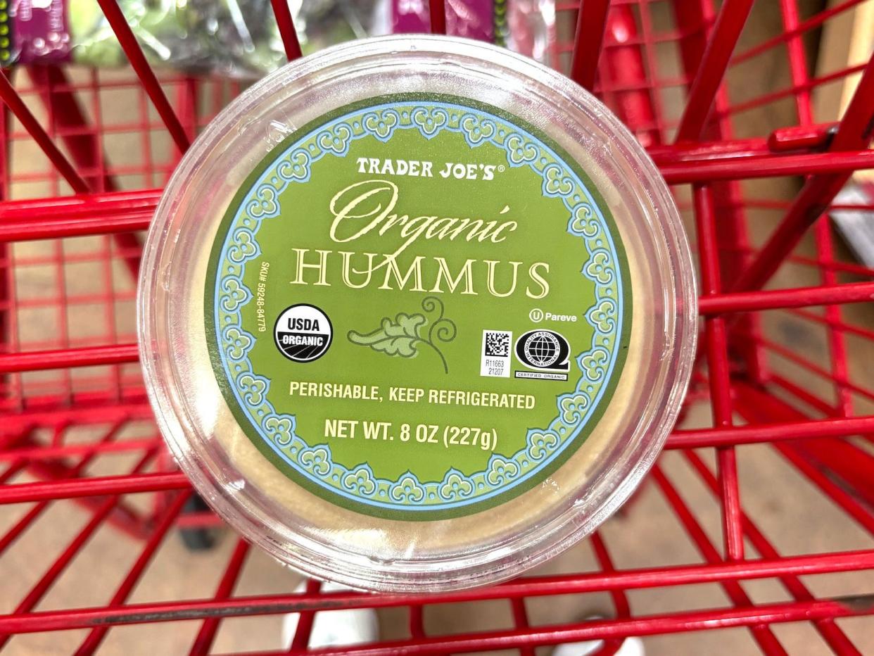 A circular container of Trader Joe's organic hummus.