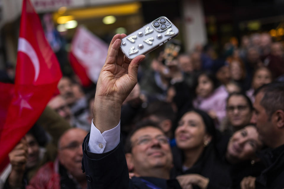 Istanbul Mayor and Republican People's Party, or CHP, candidate for Istanbul Ekrem Imamoglu, center, takes a photograph with supporters during a campaign rally, in Istanbul, Turkey, Tuesday, March 19, 2024. On Sunday, millions of voters in Turkey head to the polls to elect mayors and administrators in local elections which will gauge President Recep Tayyip Erdogan’s popularity as his ruling party tries to win back key cities it lost five years ago. (AP Photo/Francisco Seco)