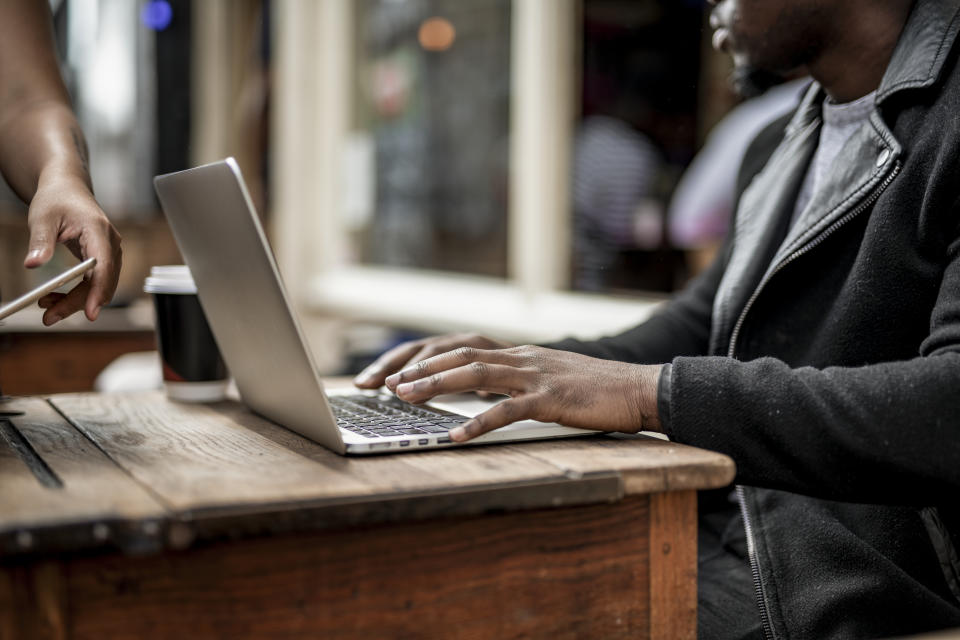 Businessman working remotely from a cafe