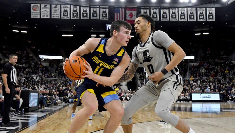 Marquette's Tyler Kolek looks for an opening against Providence's Alyn Breed during a game in December in Providence.