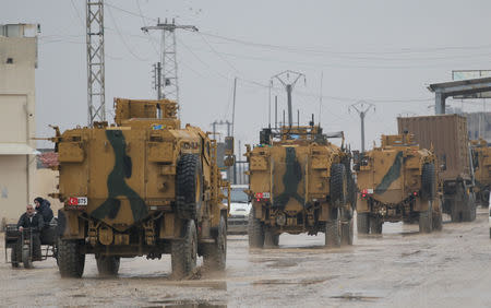 Turkish military vehicles ride at the Bab el-Salam border crossing between the Syrian town of Azaz and the Turkish town of Kilis, in Syria January 1, 2019. Picture taken January 1, 2019. REUTERS/Khalil Ashawi