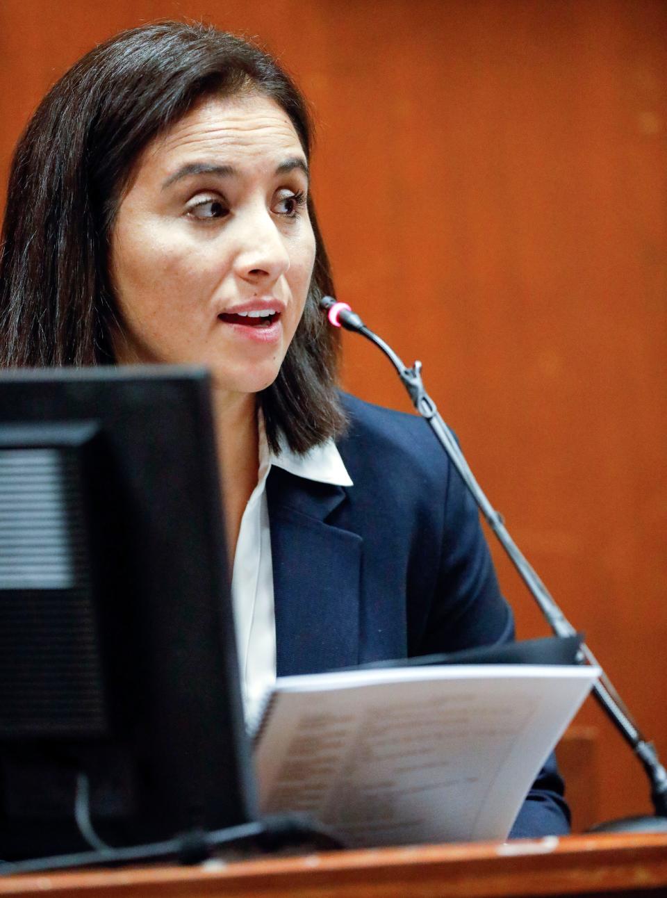 Former Iowa City police officer Pamela Romero holds transcripts of her interview with defendant Cristhian Bahena Rivera as she testifies during his trial at the Scott County Courthouse in Davenport, Iowa, on Thursday, May 20, 2021.