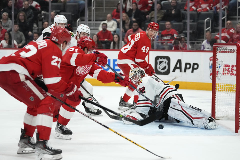 Detroit Red Wings center Dylan Larkin (71) scores on Chicago Blackhawks goaltender Alex Stalock (32) in the second period of an NHL hockey game Wednesday, March 8, 2023, in Detroit. (AP Photo/Paul Sancya)