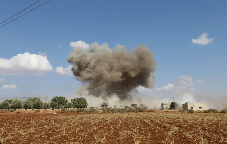 Smoke billows following Syrian government forces' bombardment around the village of Al-Muntar on the southern edges of rebel-held Idlib province