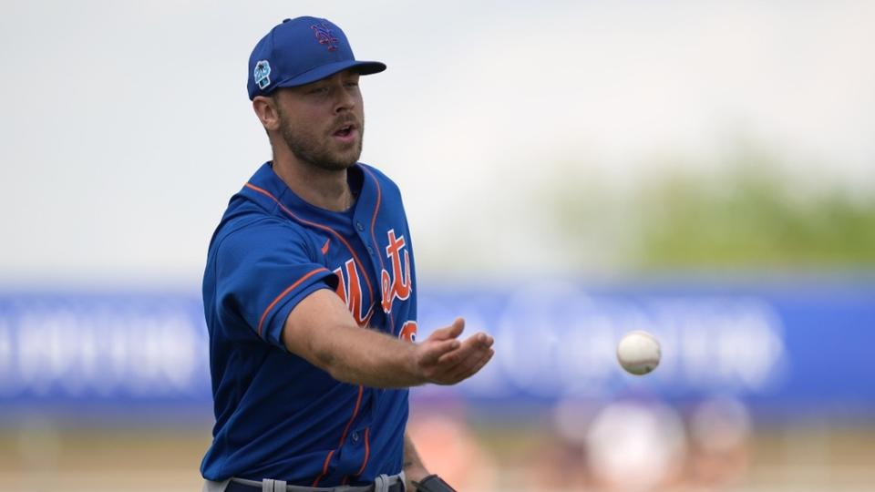 ew York Mets starting pitcher Tylor Megill (38) tosses the ball to first base for an out in the fourth inning against the Miami Marlins.