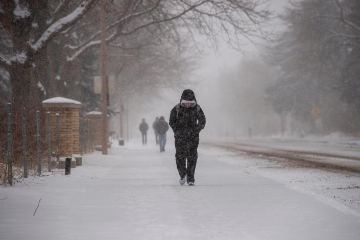 Snow falls on CSU students as they head to class on Wednesday, March 9, 2022.