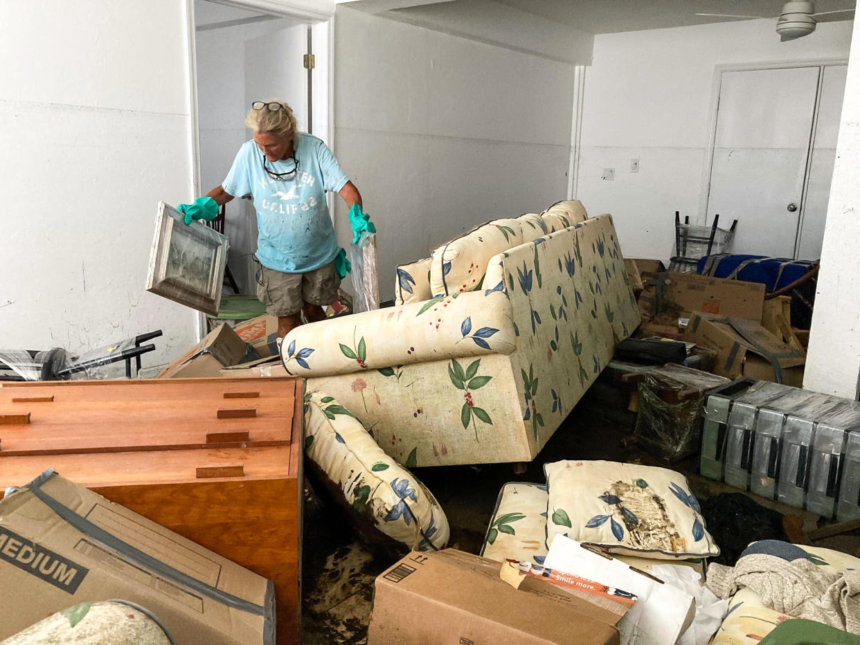Image: Resident Pamela Brislin who has lived on Sanibel Island since 2020 cleans up the damage from Hurricane Ian, on Oct. 6, 2022, in Sanibel Island, Fla. (Scott Smith / AP)