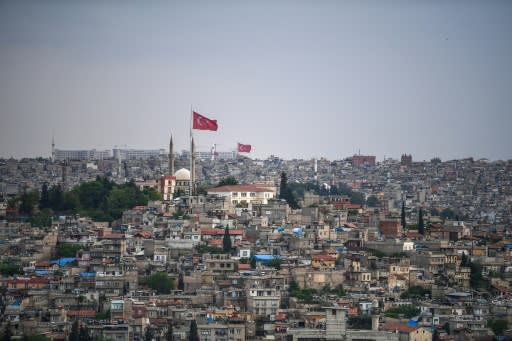 Flags flutter over the Turkish city of Gaziantep, home to around half a million Syrians who fled the civil war south of the border