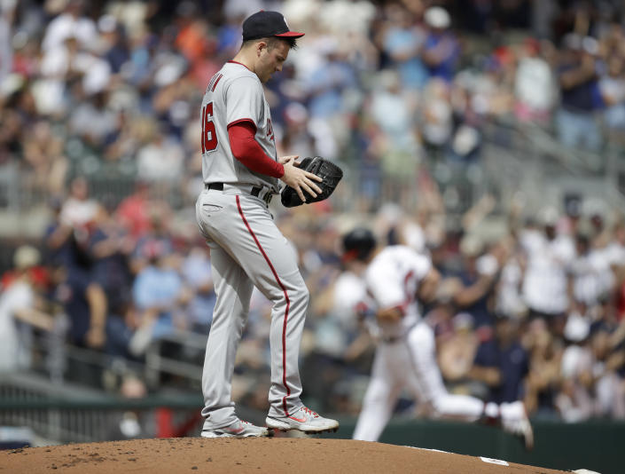 Washington Nationals' Patrick Corbin, foreground, waits for Atlanta Braves' Austin Riley, back right, to run the bases after Riley hit a two-run home run in the first inning of a baseball game Saturday, July 9, 2022, in Atlanta. (AP Photo/Ben Margot)