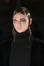 Asymmetrical hair and mismatching eye makeup to match, models at Yamamoto had their faces decorated with fence designs, looking like Edward Scissorhands got dressed up for a Halloween haunted house with the help of Pat McGrath.