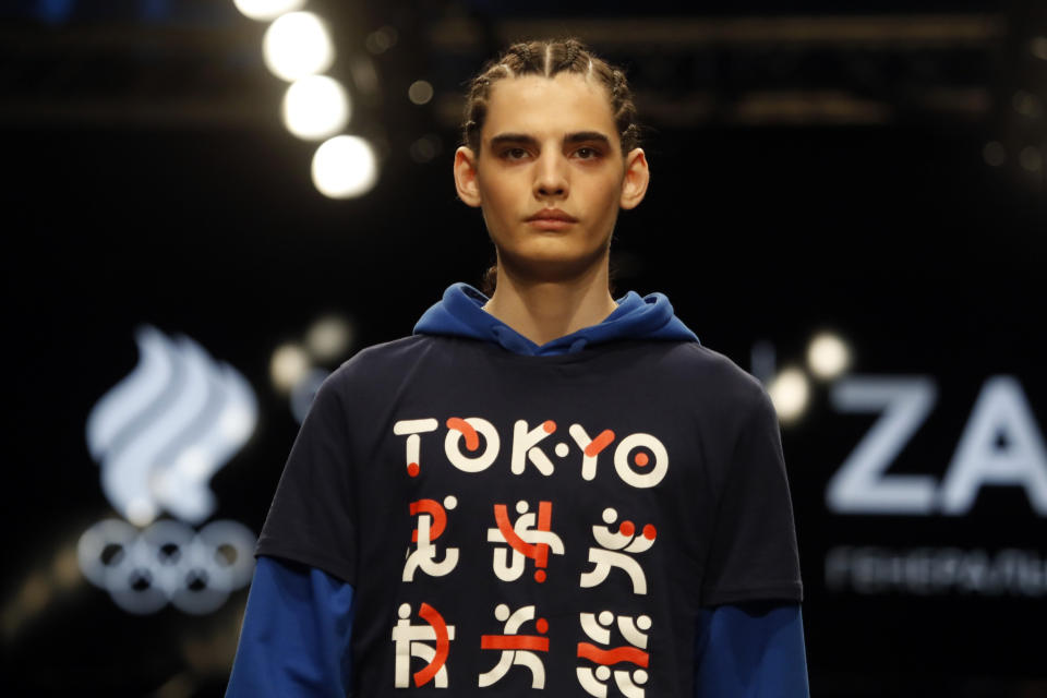 A model displays the Olympic uniforms for Russian athletes in Moscow, Russia, Wednesday, April 14, 2021. Russia presents its Olympic kit for the Tokyo Games, which shouldn't depict any symbols of the country. Russian athletes will compete at the Tokyo Olympics as neutral after the Court of Arbitration for Sport last December banned Russia from using its name, flag and anthem at any world championships for the next two years because of state-backed doping. (AP Photo/Pavel Golovkin)