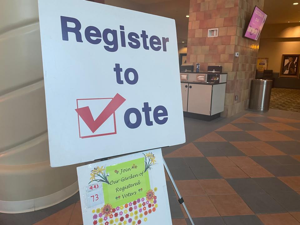 A sign at Mary Pickford Theatre in Cathedral City encourages moviegoers to register to vote before the Sept. 14 recall election. The voter registration drive organized by the Courageous Resistance of the Desert has gotten more than 900 people registered since before the 2020 election.