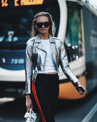 Romee Strijd owns the sports luxe trend in this metallic leather jacket and jogger bottoms. 