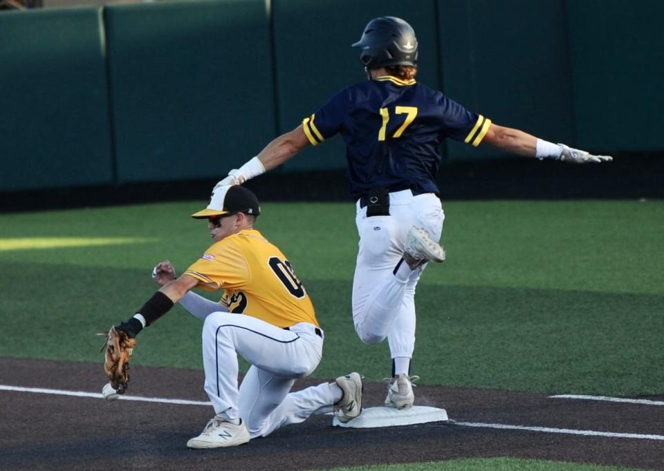 Stephenville's Cade Wright reaches base safely as Snyder's Hunter Stewart tries to field a ball at first base.