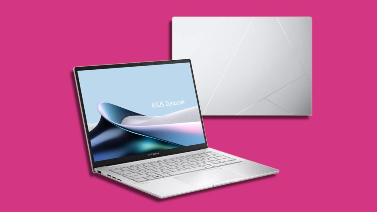  Silver laptop against pink background. 