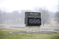 A brief shower passes by as a golf course sign highlights coronavirus preparedness Thursday, April 9, 2020, in Edina, Minn. Golf courses in Minnesota must remain closed until May 4 as part of the governor's extended stay-at-home order. (AP Photo/Jim Mone)