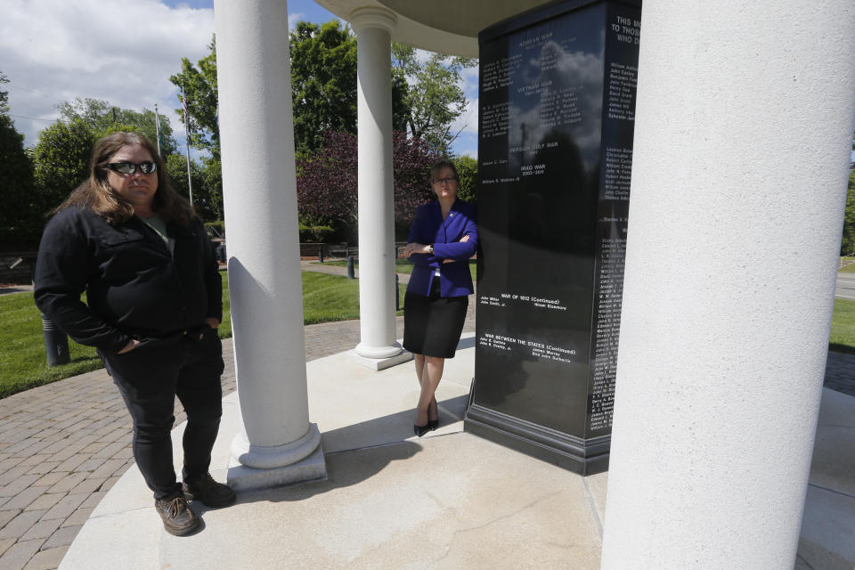 Halifax County Commonwealth's Attorney Tracy Martin, right, poses with Kevin Wynn at the Halifax County War Memorial on Wednesday May 6, 2020, in Halifax, Va. Martin has objected to the geriatric release of Debra Scribner, 66, convicted in 2012 of first-degree murder, conspiracy and a firearms charge in the death of her son-in-law, Eric Wynn, who was the brother of Kevin Wynn. A review by The Associated Press has found during a push to accelerate the review of parole-eligible inmates because of the coronavirus pandemic, Virginia released dozens of violent offenders, including killers, rapists and kidnappers, blindsiding prosecutors and victims' families who say they were not properly notified as required by law. (AP Photo/Steve Helber)