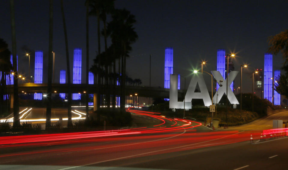 FILE - Lighted pylons at the Century Boulevard entrance to Los Angeles International Airport Saturday, Nov. 2, 2013. On Friday, Feb. 10, 2023, The Associated Press reported on stories circulating online incorrectly claiming Los Angeles International Airport is adding urinals to its women’s restrooms. (AP Photo/Reed Saxon, File)