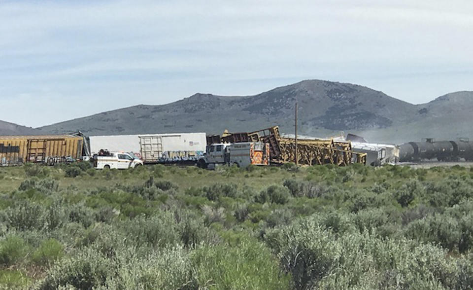 In this photo provided by the Nevada Department of Public Safety is a train derailment Wednesday, June 19, 2019, near Wells, Nev. A train carrying military munitions derailed in the high desert of northeast Nevada on Wednesday, closing an interstate for about an hour before emergency crews determined there was no danger. No injuries were reported. Officials say cars carrying the munitions to a Nevada Army depot were not among those that derailed near the community of Wells not far from the Utah-Nevada state line. (Nevada Department of Public Safety via AP)