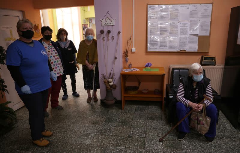 Woman waits to receive coronavirus disease (COVID-19) vaccine at a care home in Sofia