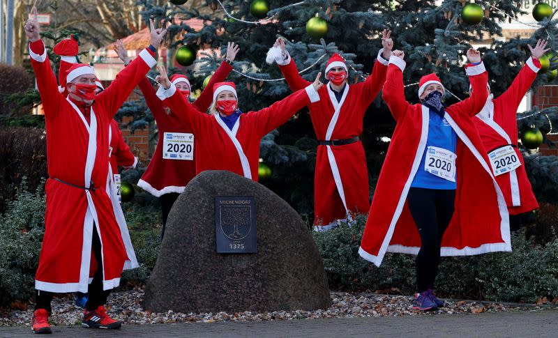 People dressed as Santa Claus race through the streets of Michendorf