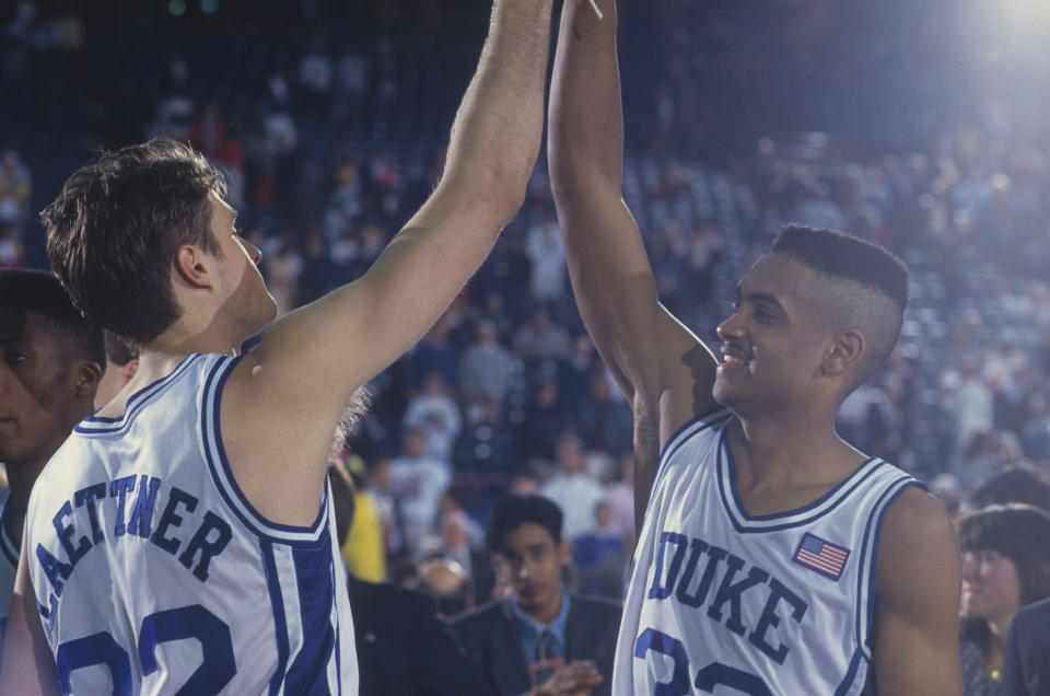 1991: Duke players Grant Hill and Christian Laettner high-five each other in celebration during the NCAA Championship against Kansas in 1991. Duke defeated Kansas 72-65. (Photo by Focus on Sport via Getty Images)